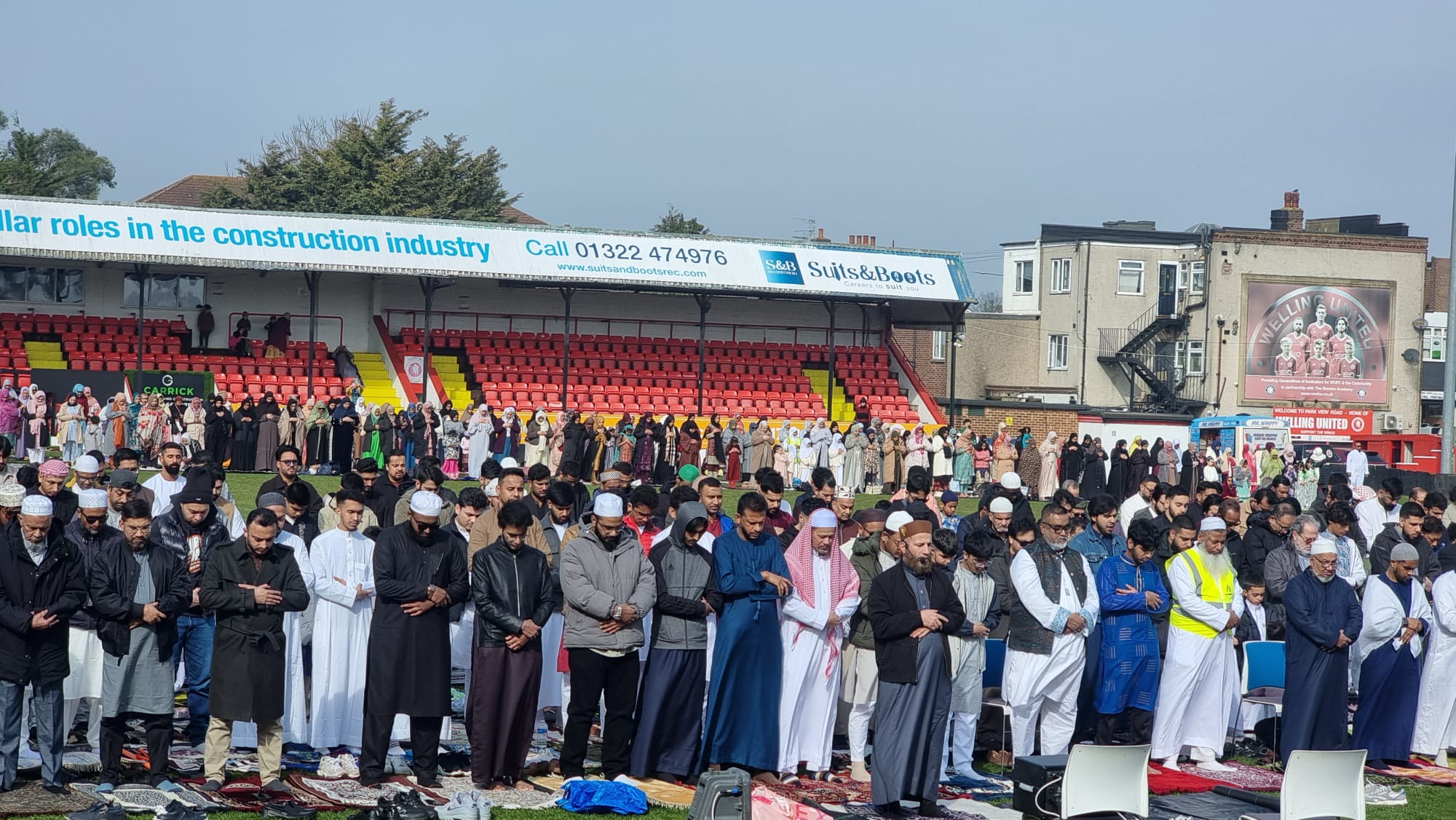 Rows of worshippers standing in prayer at the Eid gathering