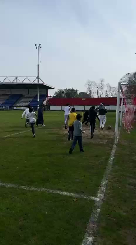 Children playing football on the pitch after prayer